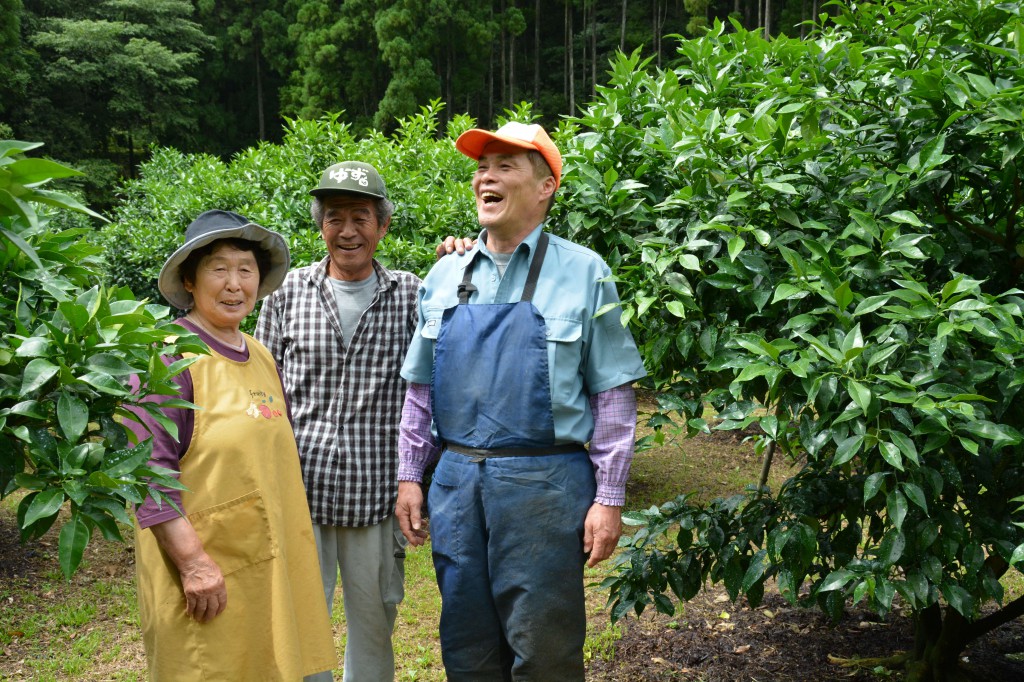 Farmers stand in front of Yuzu trees in Umaji, Kochi Prefecture.
