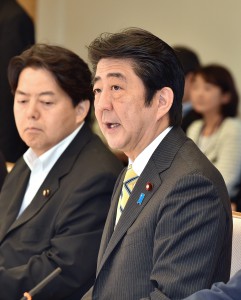 Prime Minister Shinzo Abe speaks Tuesday, June 24, at the government’s headquarters for agricultural revitalization, as agriculture minister Yoshimasa Hayashi looks on.