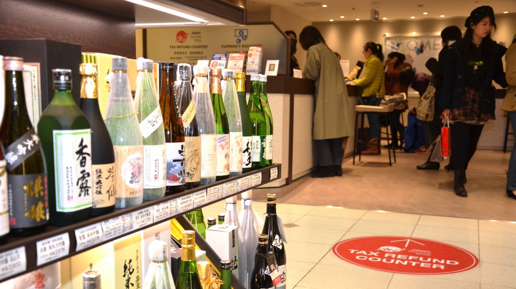 Bottles of sake, which is popular among foreign tourists, are displayed at Matsuya Ginza department store, with a tax refund counter in the back.