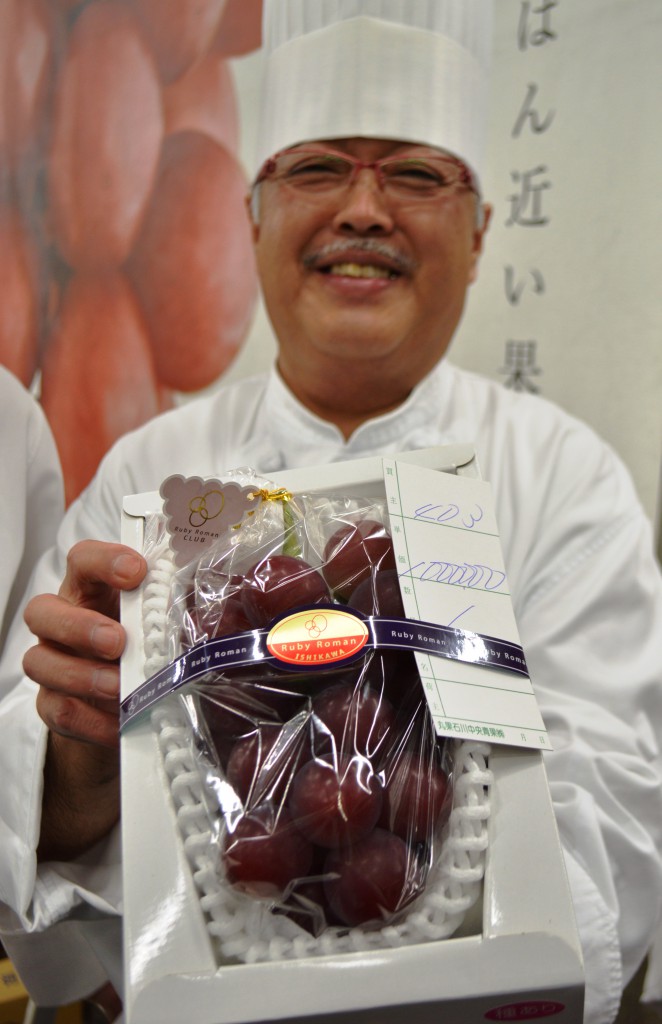 Head chef of the Hotel Nikko Kanazawa holding world’s most expensive Ruby Roman grapes ever (in Kanazawa-shi, Ishikawa Prefecture)