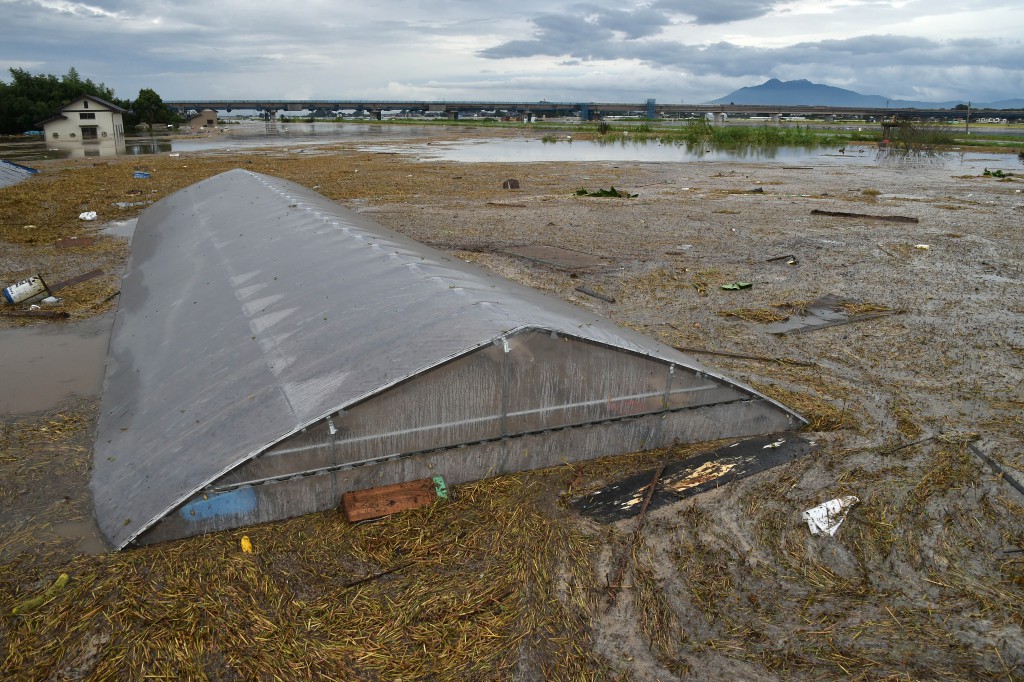 A greenhouse in Joso, Ibaraki Prefecture, is submerged in water nearly up to the roof at 4:15 p.m. Thursday, Sept. 10, due to the bank collapse of the Kinugawa River. Rice paddies and houses nearby are also flooded
