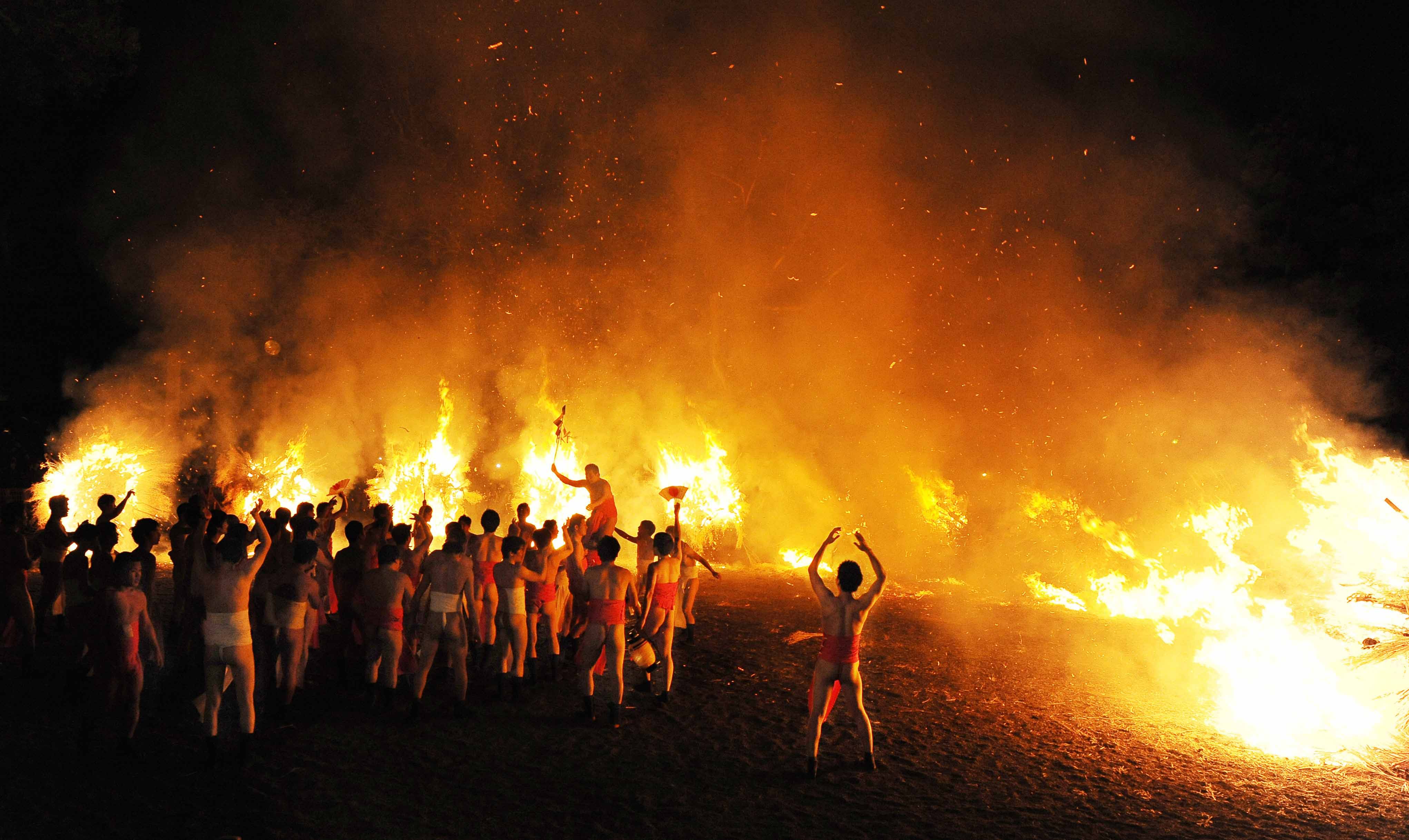 Torch bearers dancing wildly under a shower of sparks (in Moriyama-shi, Shiga Prefecture)